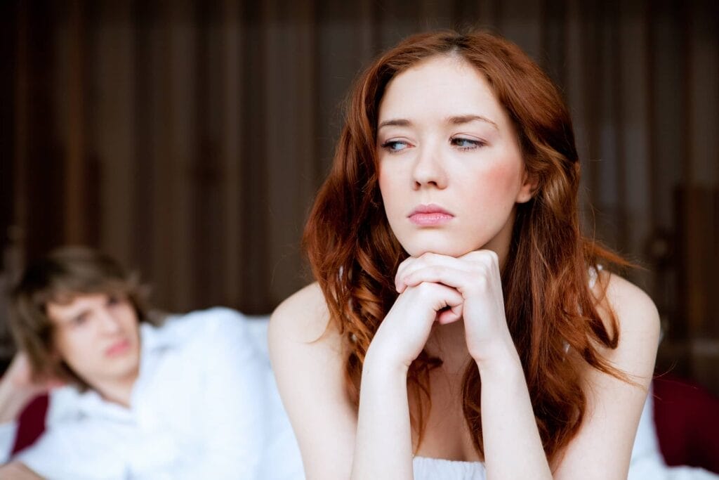 a female looking with doubts at the man in the background
