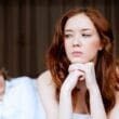 a female looking with doubts at the man in the background