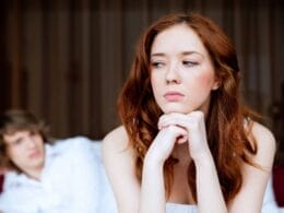 a female looking with doubts at the man in the background